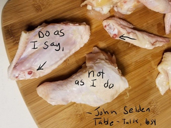 Cut raw wing pieces with arrows marking ends sliced through the bone