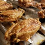Golden, crispy baked chicken wings on a wire baking rack
