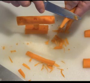 Carrot crossbar resting on its base while a knife tapers carrot uprights